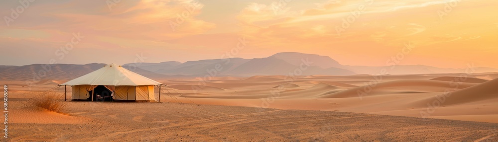 Sunset over a vast desert landscape with a traditional tent and distant mountains, portraying serenity and isolation in nature. Sunset over a vast desert landscape with a traditional tent and distant mountains, portraying serenity and isolation in nature.