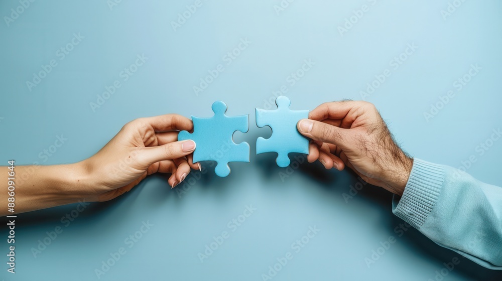 A minimalistic image of hands connecting puzzle pieces. A minimalistic image of hands connecting puzzle pieces.