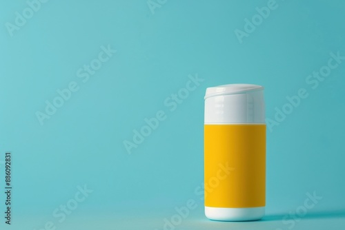 White Plastic Bottle With Yellow Label on a Blue Background