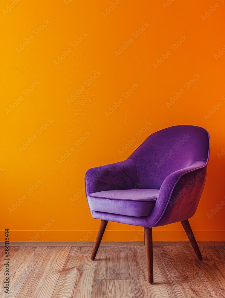 Purple armchair against bright orange wall on wooden floor Purple armchair against bright orange wall on wooden floor