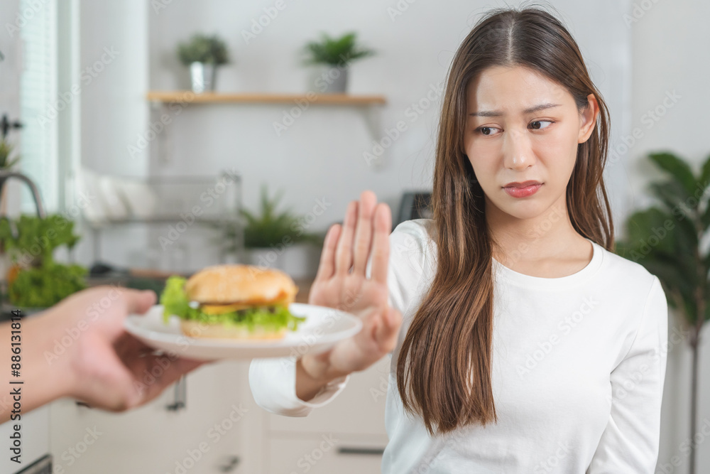 Diet, struggle asian young woman hand gesture reject to eat burger, push out or deny fast, junk food when person bring hamburger, control body overweight, eat low fat food healthy, getting weight loss Diet, struggle asian young woman hand gesture reject to eat burger, push out or deny fast, junk food when person bring hamburger, control body overweight, eat low fat food healthy, getting weight loss