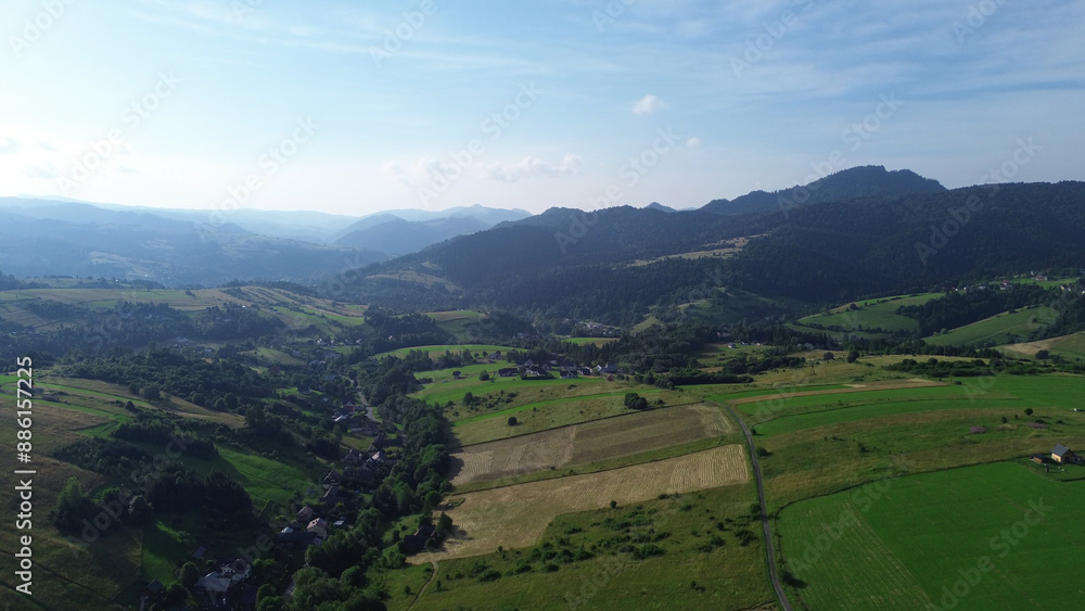 Aerial view of lush green fields and distant mountains Aerial view of lush green fields and distant mountains