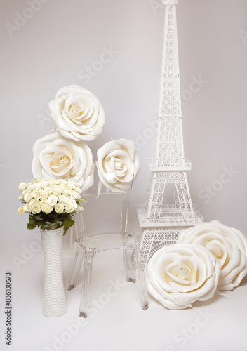 lihgt photozone in photostudio with giant white roses and a tower