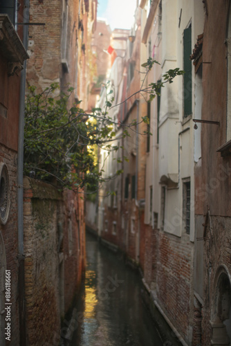 Sunlit Canal with Classic Venetian Architecture photo