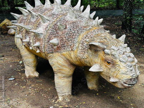 Sajchania dinosaur. Realistic figure of an Sajchania dinosaur inforest park in Kazimierz Sosnowiec. Prehistoric predator create a fascinating element of the landscape, attracting dinosaur lovers. photo