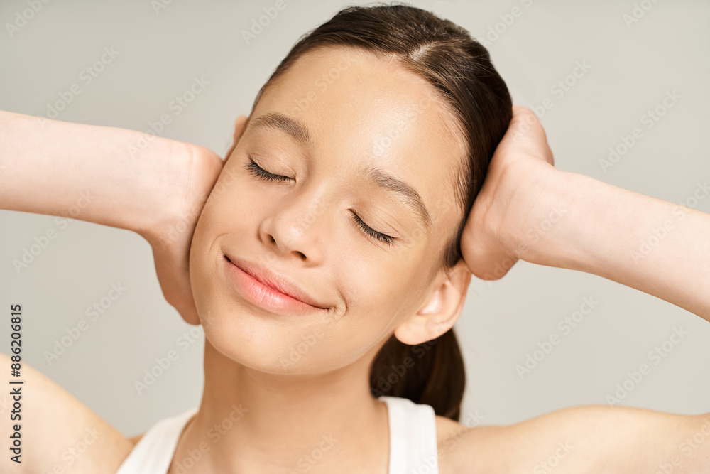 Naklejka premium A stylish, vibrant teenage girl with hands on head in a pose of distress and contemplation.