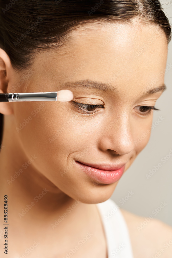 A teenage girl in vibrant attire actively paints her face with a brush. A teenage girl in vibrant attire actively paints her face with a brush.