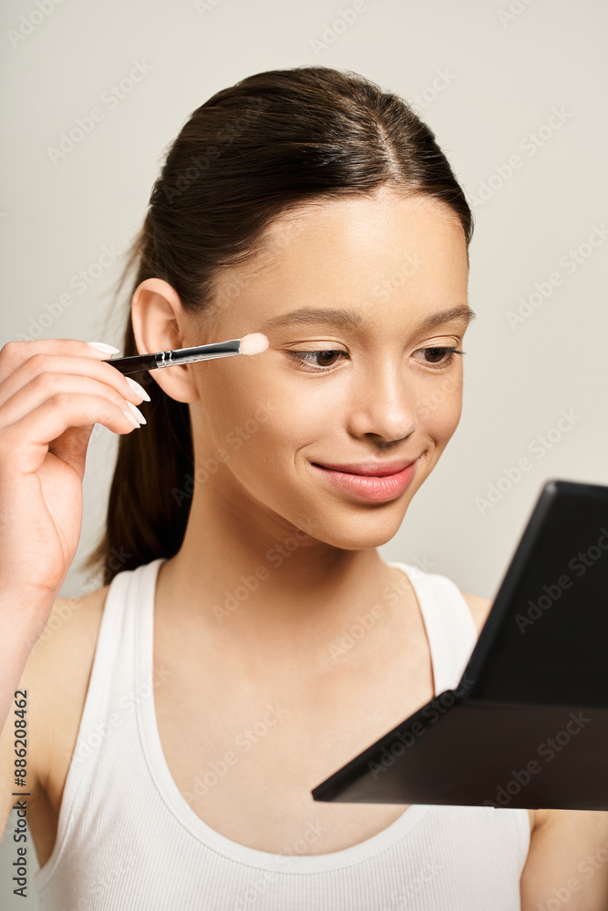 A stylish teenage girl energetically using a brush to apply makeup on her own face, showcasing a fun and artistic form of self-expression. A stylish teenage girl energetically using a brush to apply makeup on her own face, showcasing a fun and artistic form of self-expression.