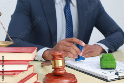 A businessman in a suit sits at a table discussing the Clean Energy Act, which incentivizes renewable energy adoption, clean raw material use in energy production, and energy-efficient transportation.