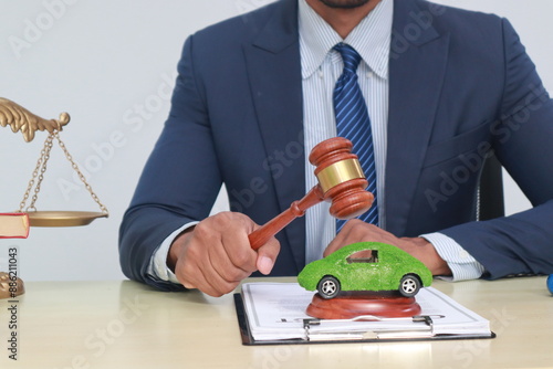 A businessman in a suit sits at a table discussing the Clean Energy Act, which incentivizes renewable energy adoption, clean raw material use in energy production, and energy-efficient transportation. photo