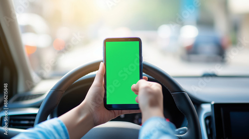 Driver Using Smartphone with Green Screen While Driving.Safety and navigation concepts.