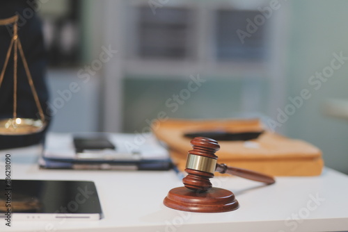 Judge gavel with Justice lawyers having team meeting at law firm background. Concepts of Law and Legal services.