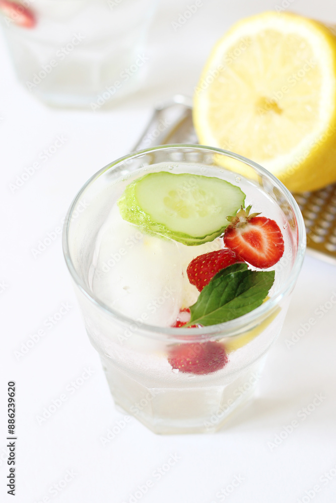 Iced Lemon Flavored Water with Fresh Strawberries, Cucumber Slices and Mint. Morning Refreshing Drinks. Iced Lemon Flavored Water with Fresh Strawberries, Cucumber Slices and Mint. Morning Refreshing Drinks.