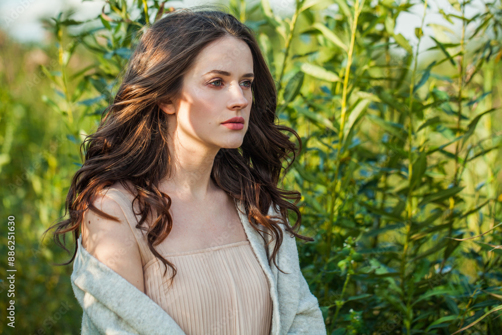 Dreaming healthy brunette woman with long hairstyle and fresh skin walking outdoors Dreaming healthy brunette woman with long hairstyle and fresh skin walking outdoors