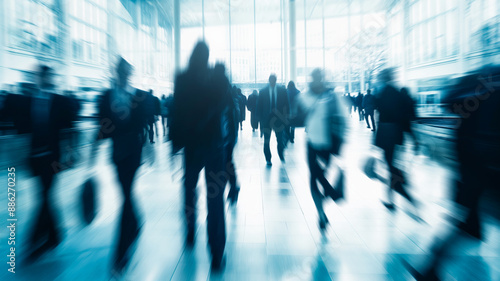 Creative background of urban or business people in motion. Blurred backdrop with defocused peopled in motion in office space.