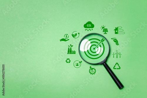 Environment target for green businesses concept, magnifying glass focus to green target icon for social business strategy and business development with environmental conservation goals photo