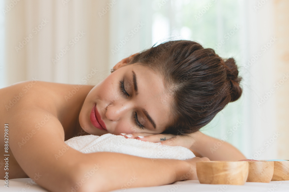 Beautiful woman lying down on the bed relax in spa salon with massage. Beautiful woman lying down on the bed relax in spa salon with massage.