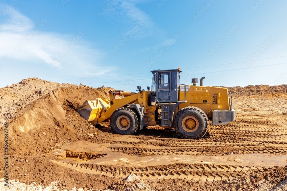 Heavy Loader Transporting Earth at Urban Construction Site Heavy Loader Transporting Earth at Urban Construction Site