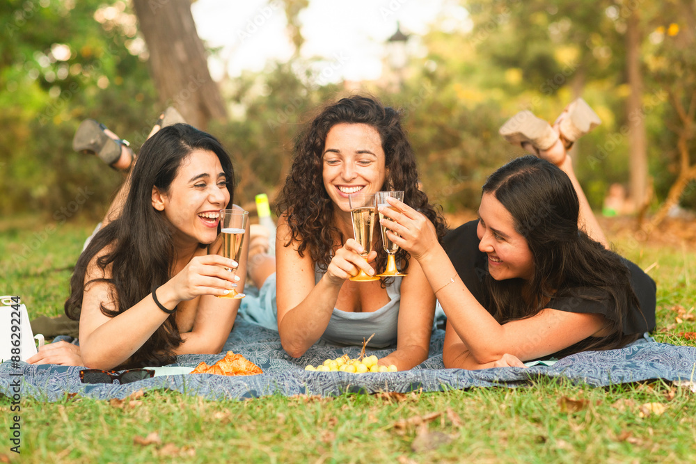 girlfriends smiling being happy at the park with a drink girlfriends smiling being happy at the park with a drink