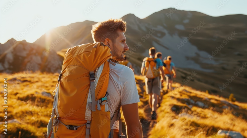 A line of backpackers traverses through mountainous terrain during the golden hour, highlighted by sunlit grass and evening sky, representing adventure and camaraderie. A line of backpackers traverses through mountainous terrain during the golden hour, highlighted by sunlit grass and evening sky, representing adventure and camaraderie.