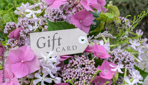 Summer bouquet with pink hydrangeas, soapwort, oregano and card with English text: Gift card 