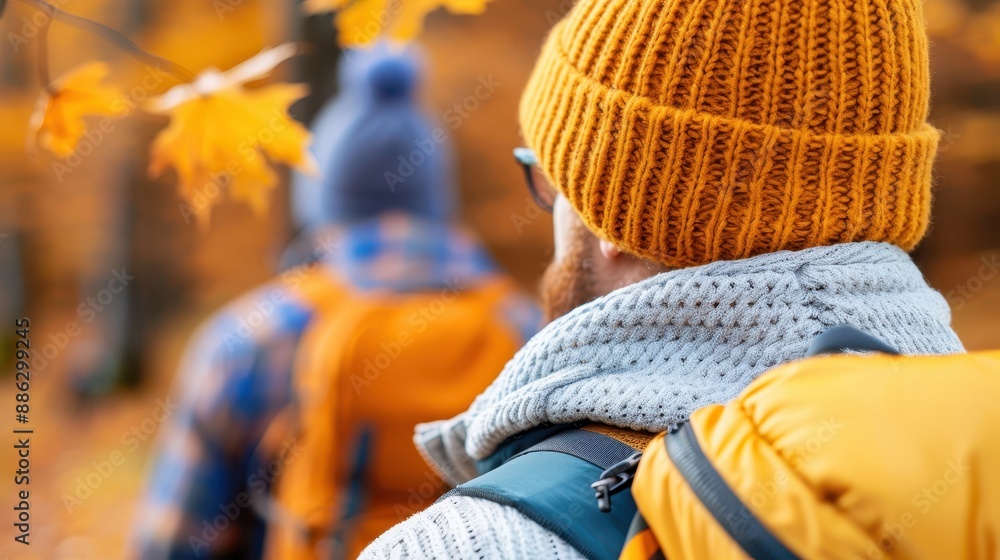 A group of backpackers hiking through a beautiful autumn forest, donning warm hats and carrying backpacks, showcasing the spirit of exploration and the changing seasons. A group of backpackers hiking through a beautiful autumn forest, donning warm hats and carrying backpacks, showcasing the spirit of exploration and the changing seasons.