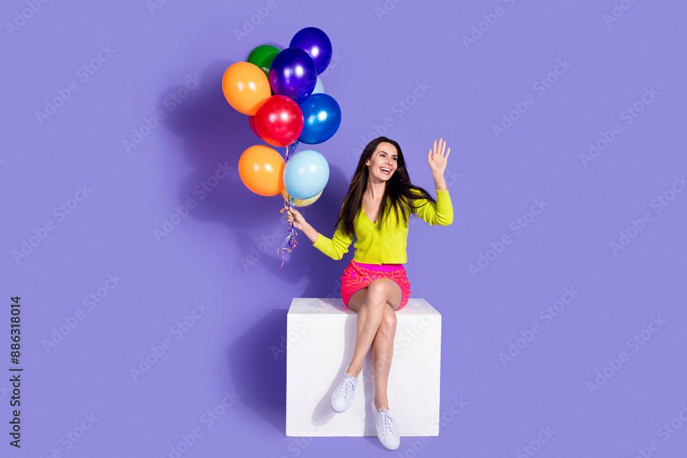 Photo of adorable positive nice girl dressed stylish clothes hi empty space isolated on purple color background Photo of adorable positive nice girl dressed stylish clothes hi empty space isolated on purple color background