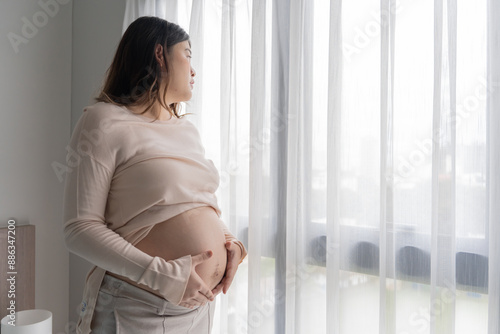 Pregnant asian woman holds hands on belly touching her baby caring about her health Beautiful happy pregnant woman tender mood photo of pregnancy Free Download Pregnant asian woman holds hands on belly touching her baby caring about her health Beautiful happy pregnant woman tender mood photo of pregnancy - GFXLoad