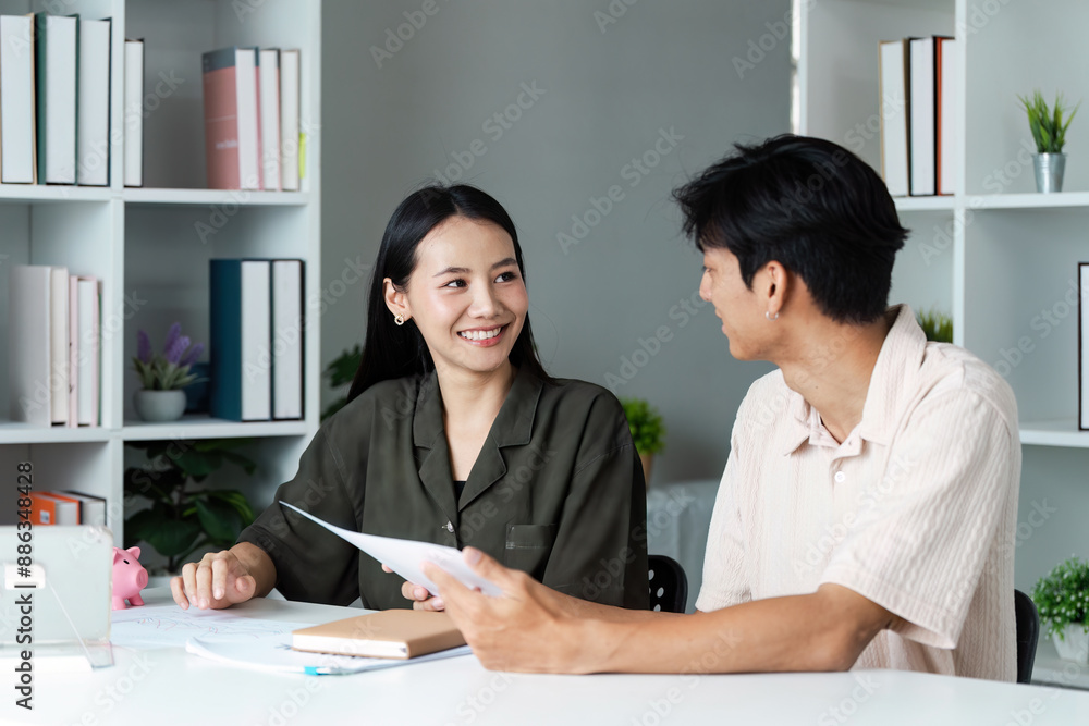 Young Couple Planning Financial Savings Together at Home with Documents and Piggy Bank Young Couple Planning Financial Savings Together at Home with Documents and Piggy Bank