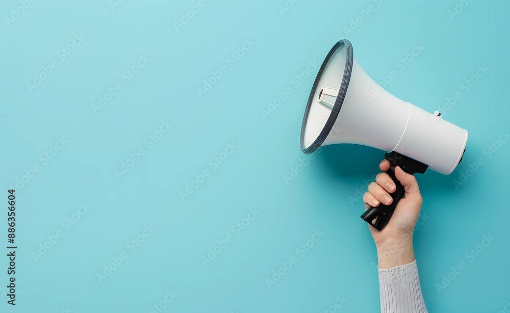© MD - Hand Holding Megaphone on Blue Background