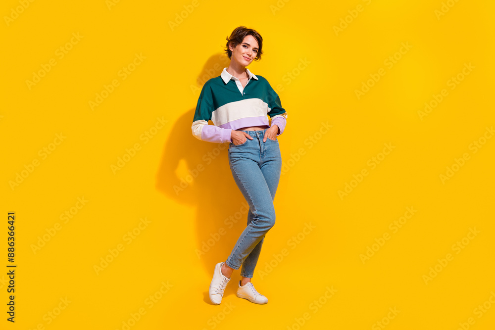 Fototapeta premium Full length photo of cute adorable lady dressed polo shirt smiling walking empty space isolated yellow color background