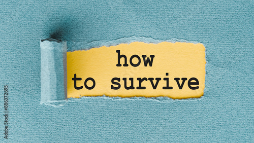 Torn Paper Reveals the Phrase How to Survive on a Blue Background