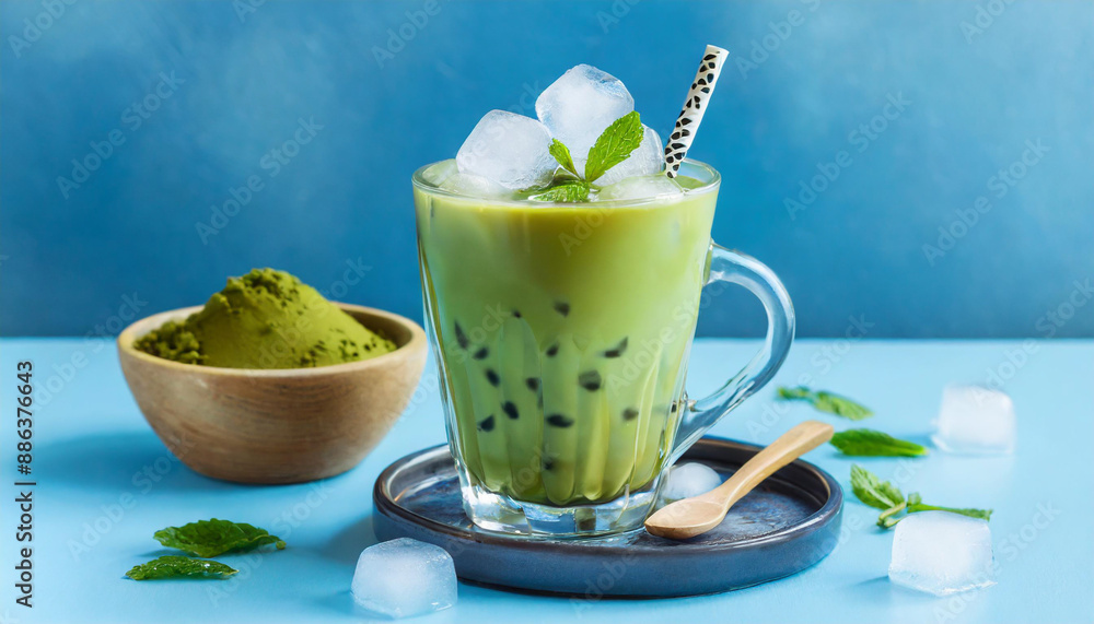 Green matcha bubble tea with ice cubes in cup on blue background. Antioxidant and dietary vegan cocktail for healthy breakfast or snack. Green matcha bubble tea with ice cubes in cup on blue background. Antioxidant and dietary vegan cocktail for healthy breakfast or snack.