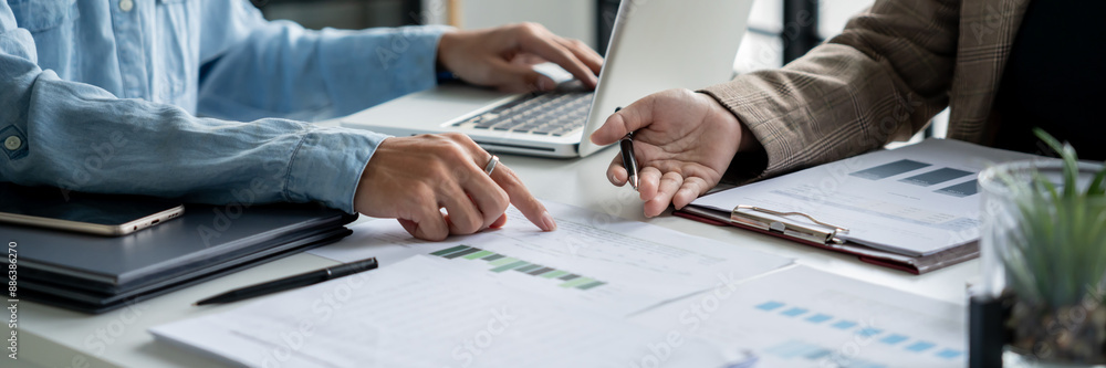 Two colleagues working analytic in office Two colleagues working analytic in office