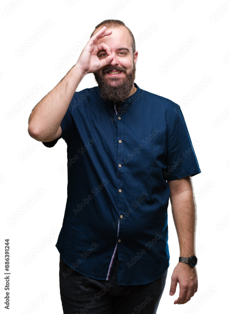 Young caucasian hipster man over isolated background doing ok gesture with hand smiling, eye looking through fingers with happy face. Young caucasian hipster man over isolated background doing ok gesture with hand smiling, eye looking through fingers with happy face.