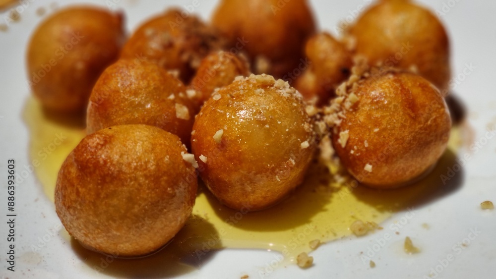 loukoumades with honey in the plate loukoumades with honey in the plate
