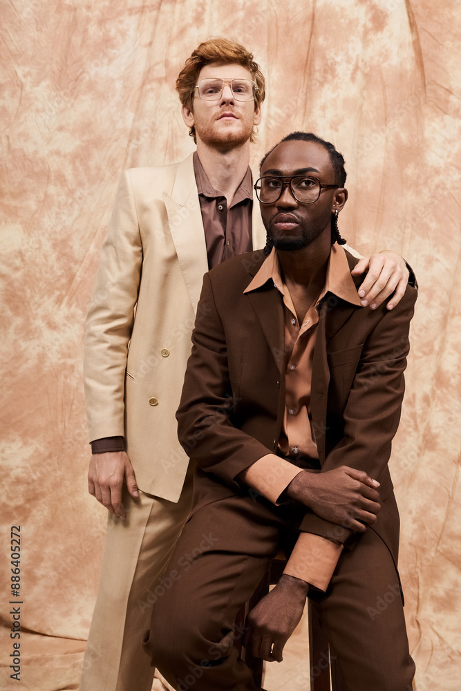 Two handsome men in elegant attire standing side by side.