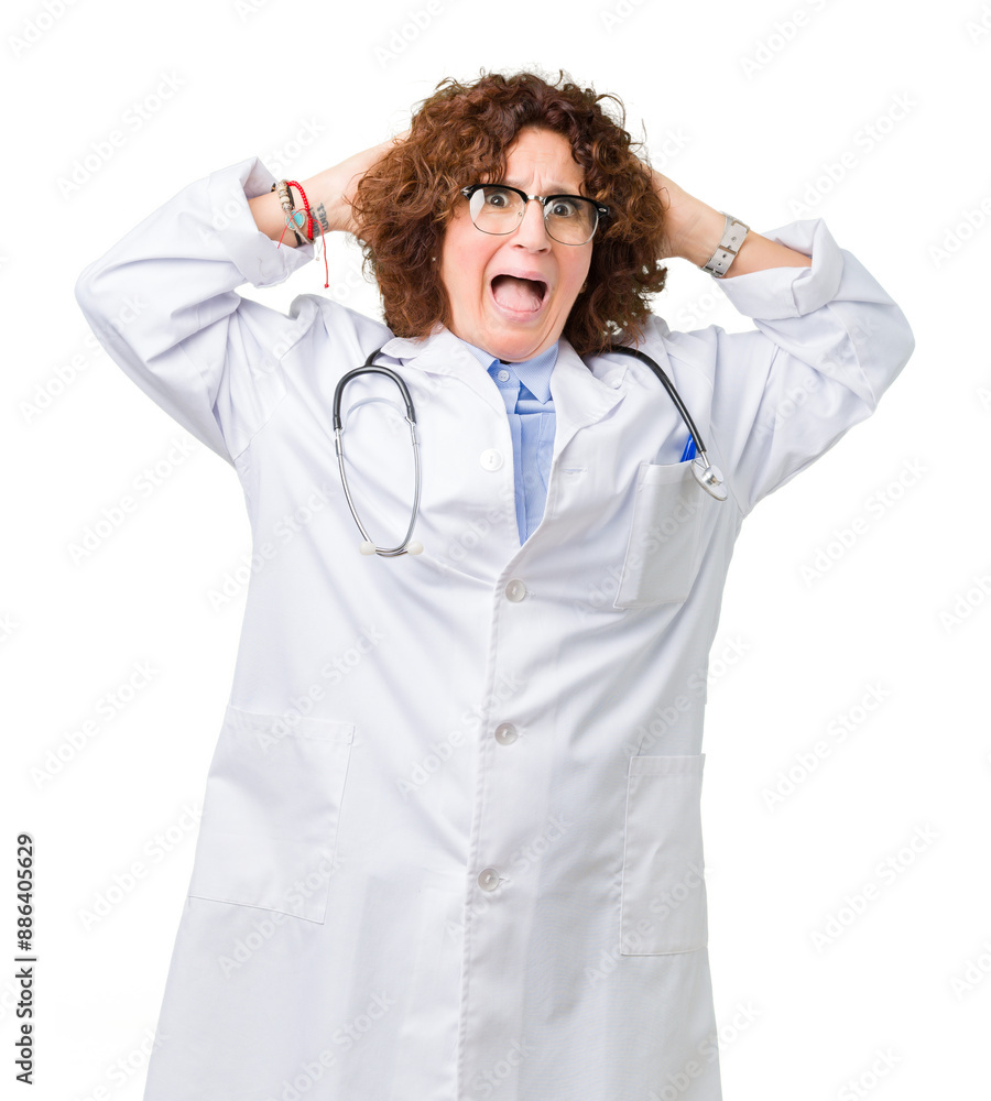 Middle ager senior doctor woman over isolated background Crazy and scared with hands on head, afraid and surprised of shock with open mouth Middle ager senior doctor woman over isolated background Crazy and scared with hands on head, afraid and surprised of shock with open mouth
