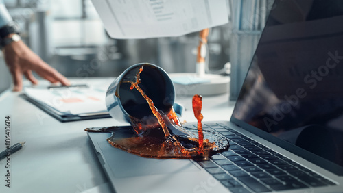 Obraz na płótnie Office Manager Accidentally Spilling Hot Coffee on Working Laptop Computer with Business Presentation Or Financial Reports For Large Company