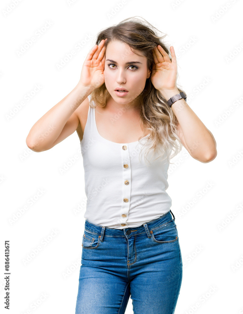 Beautiful young blonde woman over isolated background Trying to hear both hands on ear gesture, curious for gossip. Hearing problem, deaf Beautiful young blonde woman over isolated background Trying to hear both hands on ear gesture, curious for gossip. Hearing problem, deaf