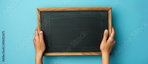 Hand holding a blank chalkb...