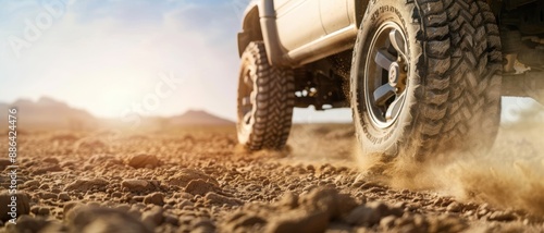 A close-up of an off-road truck s tires gripping the sandy terrain, illustrating the ruggedness of desert driving photo