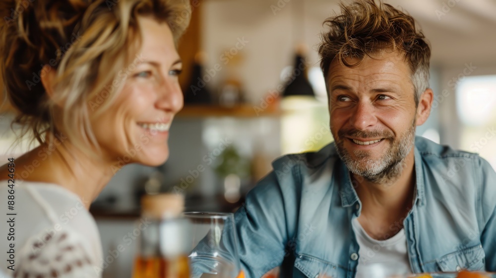 A cheerful couple, with warm smiles, enjoying a relaxing breakfast at their cozy home, indicating a close bond and joyful moments together in a comfortable environment. A cheerful couple, with warm smiles, enjoying a relaxing breakfast at their cozy home, indicating a close bond and joyful moments together in a comfortable environment.