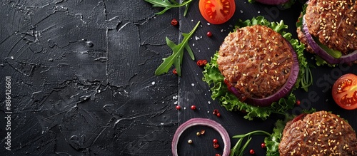 Obraz  z motywem Top view of a homemade organic minced beef burger on a slate board with a copy space image background fitting a healthy food blog or cooking class theme