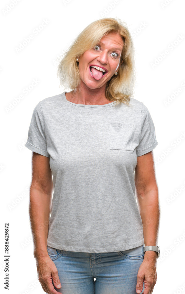 Fototapeta premium Middle age blonde woman over isolated background sticking tongue out happy with funny expression. Emotion concept.