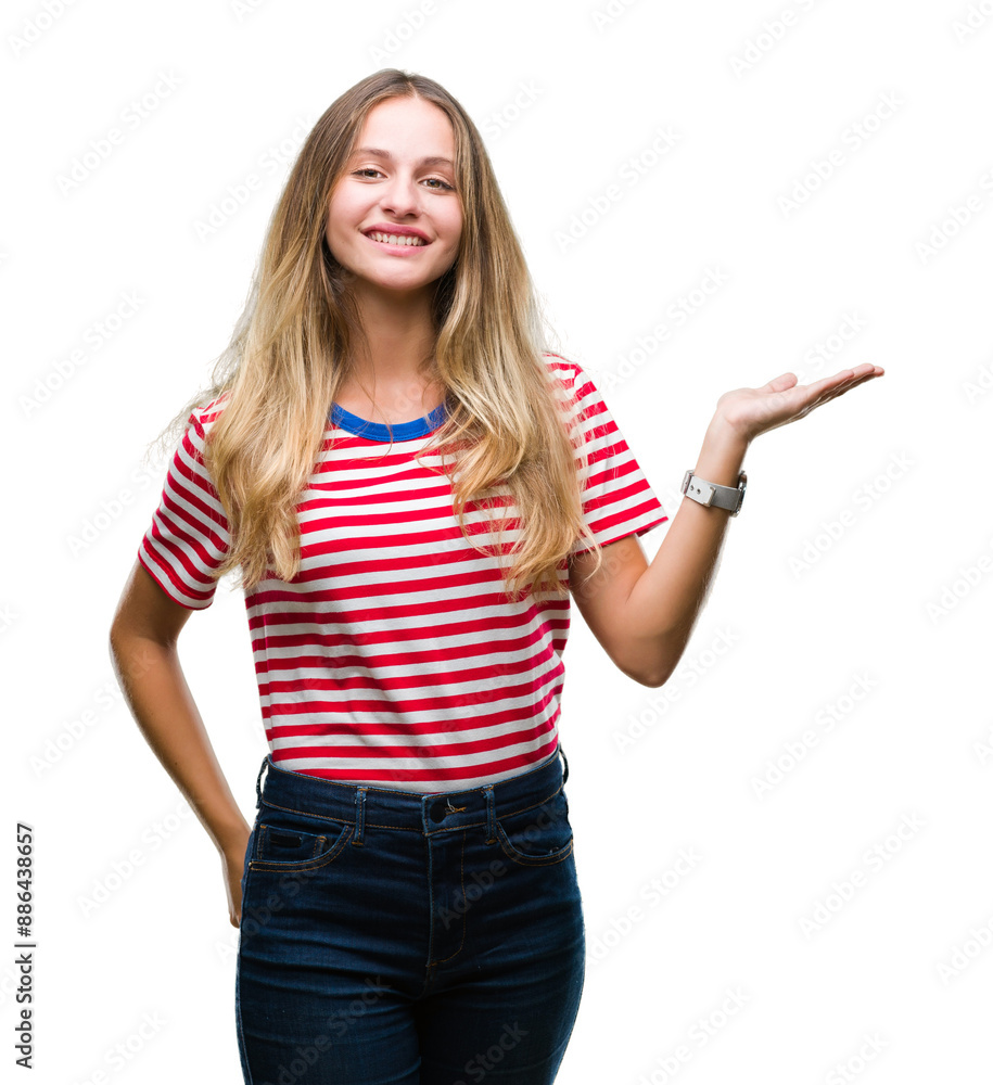 Young beautiful blonde woman over isolated background smiling cheerful presenting and pointing with palm of hand looking at the camera. Young beautiful blonde woman over isolated background smiling cheerful presenting and pointing with palm of hand looking at the camera.
