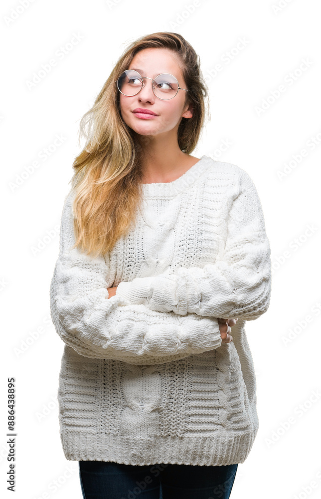 Young beautiful blonde woman wearing winter sweater and sunglasses over isolated background smiling looking side and staring away thinking. Young beautiful blonde woman wearing winter sweater and sunglasses over isolated background smiling looking side and staring away thinking.