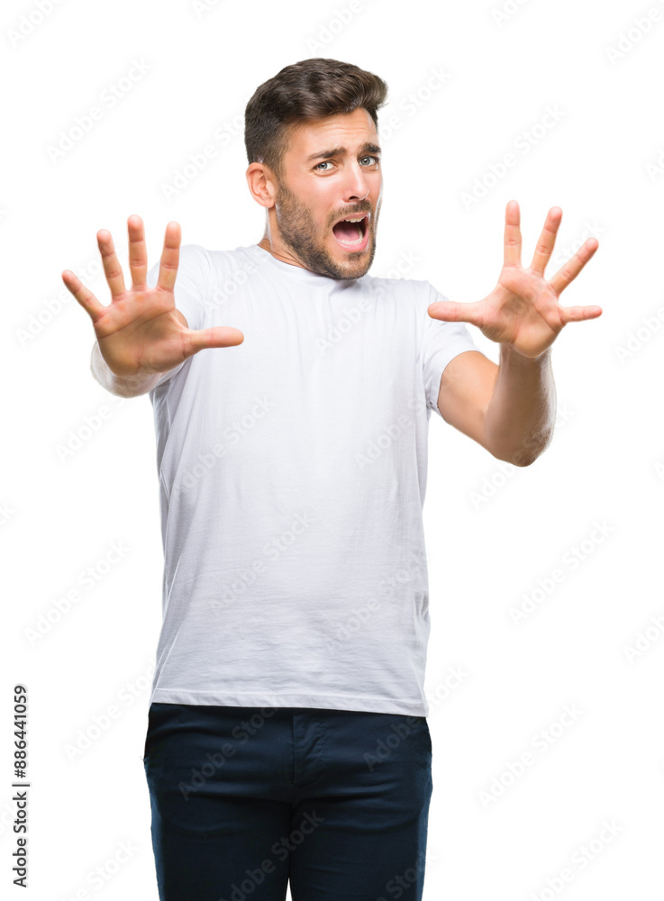Young handsome man over isolated background afraid and terrified with fear expression stop gesture with hands, shouting in shock. Panic concept. Young handsome man over isolated background afraid and terrified with fear expression stop gesture with hands, shouting in shock. Panic concept.