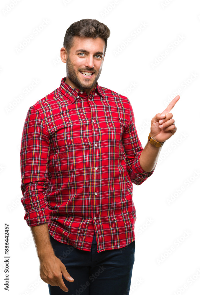 Young handsome man over isolated background with a big smile on face, pointing with hand and finger to the side looking at the camera. Young handsome man over isolated background with a big smile on face, pointing with hand and finger to the side looking at the camera.