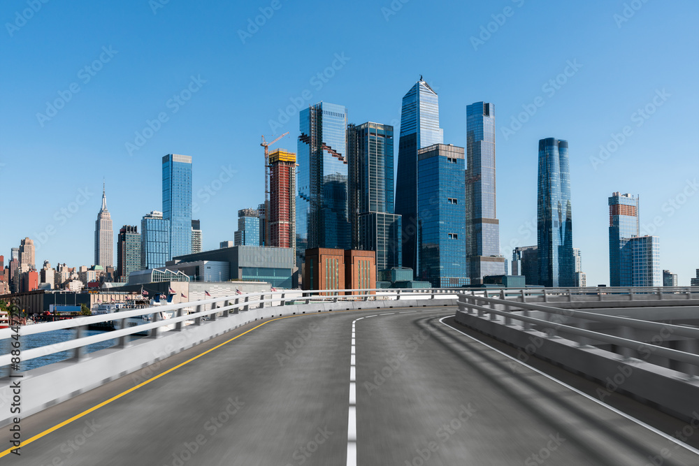 Empty urban asphalt road exterior with city buildings background. New modern highway concrete construction. Concept of way to success. Transportation logistic industry fast delivery. New York. USA. Empty urban asphalt road exterior with city buildings background. New modern highway concrete construction. Concept of way to success. Transportation logistic industry fast delivery. New York. USA.
